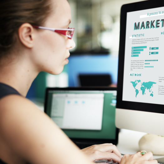 Woman working on a desktop creating modern reports