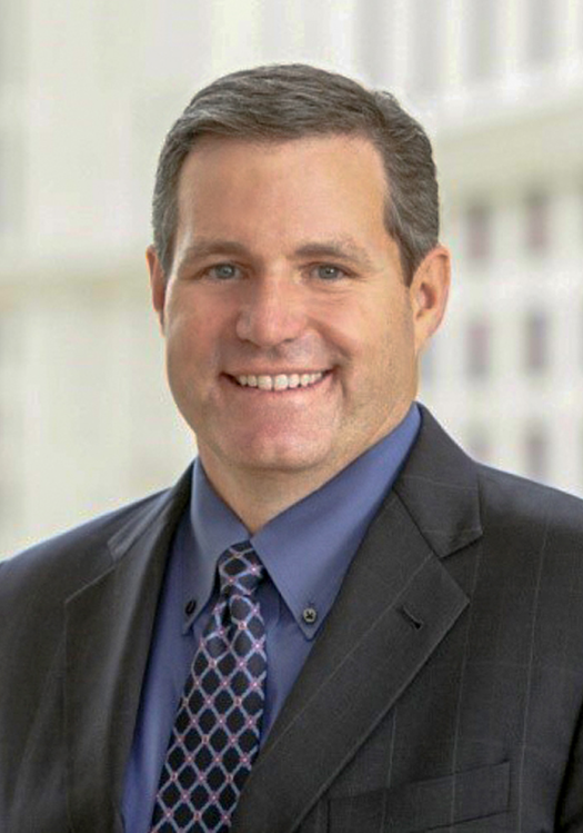 Close up of man in suit in front of building