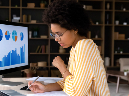 Woman working on office desk on analytics and dashboard