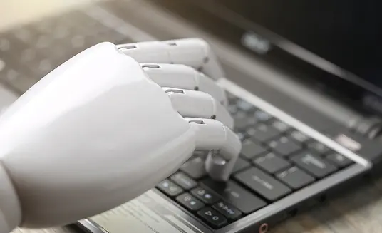 robotic hand on keyboard