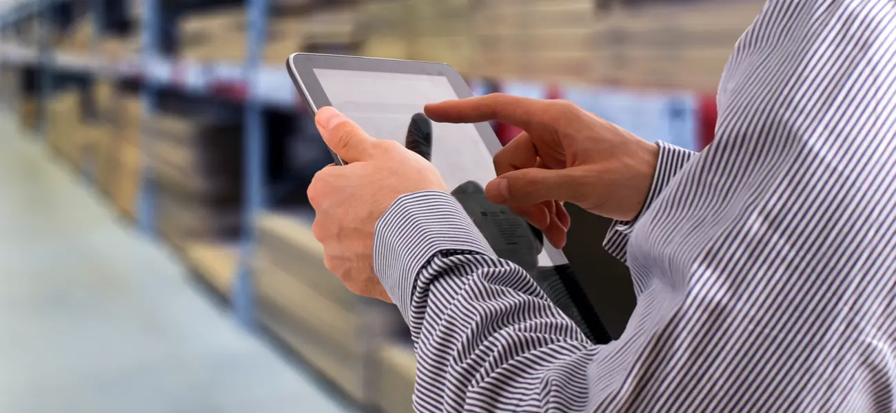 Man checking inventory on tablet